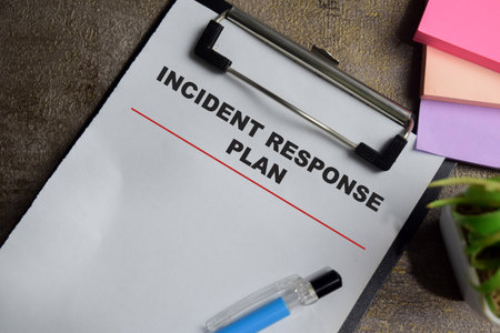 Concept of incident response plan write on clipboard isolated on Wooden Table.の写真素材