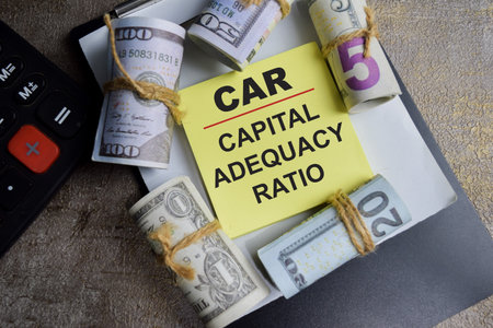 Concept of CAR - Capital Adequacy Ratio write on sticky notes isolated on Wooden Table.の写真素材