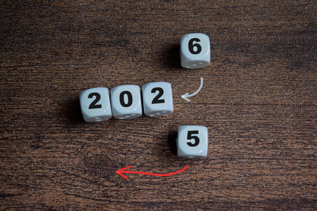 2025 to 2026 on stacked wooden cubes on the table.