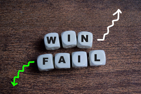 Win and failure on stacked wooden cubes on the table. Business and finance conceptの写真素材