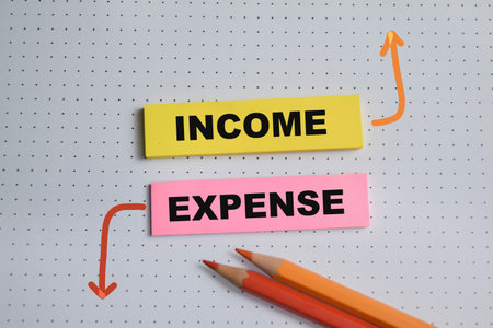Concept of Income and expense write on sticky notes isolated on Wooden Table.