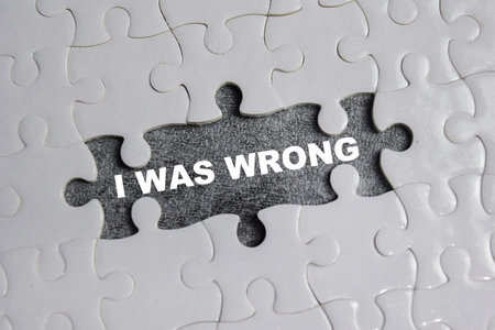 piece of jigsaw puzzle with word I was wrong. Business and finance concept