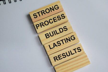 Success strong process builds lasting results on stacked wooden cubes on the table.