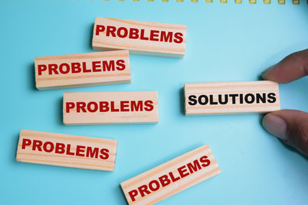 Solutions or problems on stacked wooden cubes on the table.の写真素材