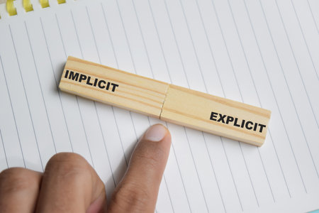 Implicit or explicit on stacked wooden cubes on the table. Business and finance conceptの写真素材