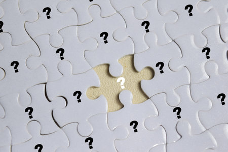 Piece of jigsaw puzzle with symbol of question mark. Business and finance conceptの写真素材