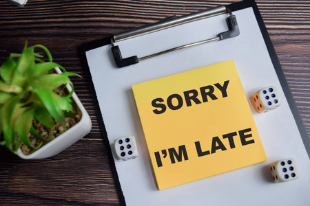 Concept of sorry I'm late write on sticky notes isolated on Wooden Table.の写真素材