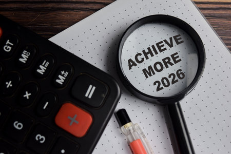 Concept of achieve more 2026 write on book with keywords isolated on Wooden Table.の写真素材