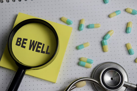 Concept of be well write on sticky notes isolated on Wooden Table.の写真素材