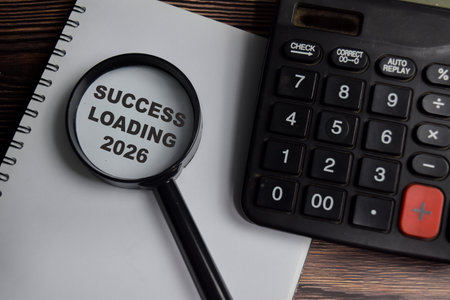 Concept of success loading 2026 write on book with keywords isolated on Wooden Table.