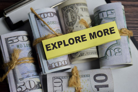 Concept of explore more write on sticky notes isolated on Wooden Table.の写真素材