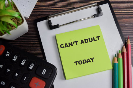 Concept of can't adult today write on sticky notes isolated on Wooden Table.の写真素材