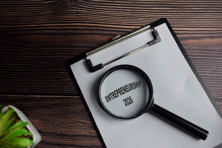 Concept of Entrepreneurship 2026 write on clipboard isolated on Wooden Table.の写真素材