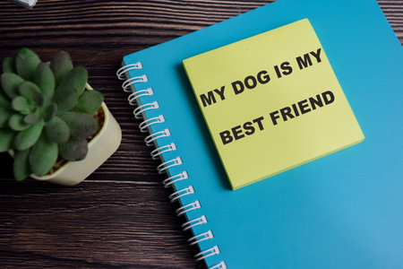 Concept of my dog is my best friend write on sticky notes isolated on Wooden Table.