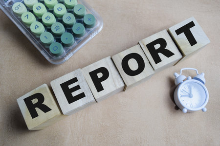 Report on stacked wooden cubes on the table.の写真素材