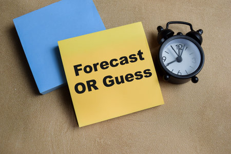 Concept of forecast or guess write on sticky notes isolated on Wooden Table.
