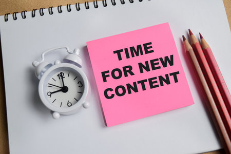 Concept of time for new content write on sticky notes isolated on Wooden Table.の写真素材