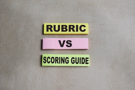 Concept of rubric vs scoring guide write on sticky notes isolated on Wooden Table.
