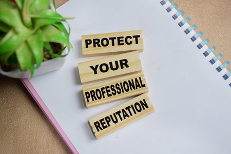 Protect your professional reputation on stacked wooden cubes on the table. Business and finance conceptの写真素材