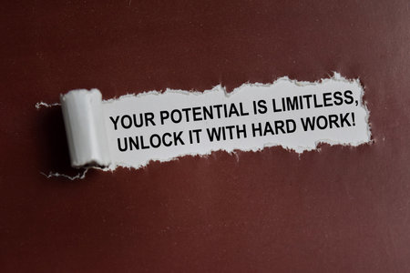 Your potential is limitless, unlock it with hard work! text written in torn paperの写真素材
