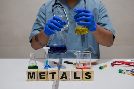 A scientist conducts experiment using test tube metals in a lab. scientific research conceptの写真素材