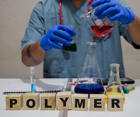 A healthcare professional exploring polymer science with flasks. scientific research conceptの写真素材