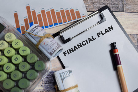 Concept of financial plan write on clipboard isolated on Wooden Table.の写真素材