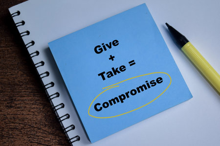 Concept of give and take compromise write on sticky notes isolated on Wooden Table.