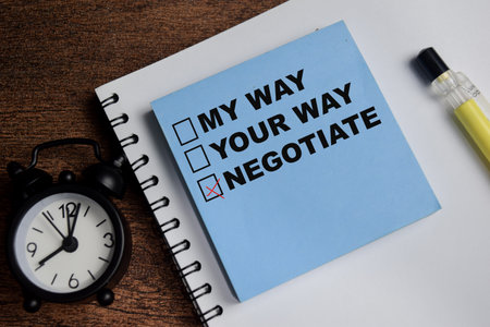 Concept of negotiate and compromised related check boxes write on sticky notes isolated on Wooden Table.の写真素材