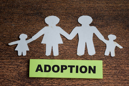 Concept of family adoption write on sticky notes isolated on Wooden Table.の写真素材