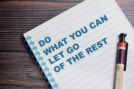 Concept of do what you can let go of the rest write on book isolated on Wooden Table.の写真素材