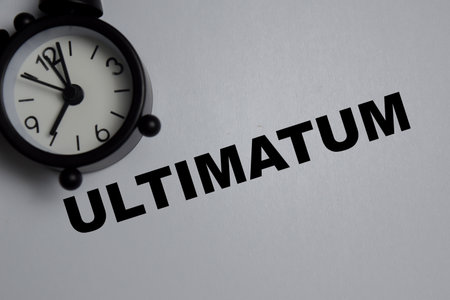 Concept of ultimatum write on book isolated on Wooden Table.の写真素材