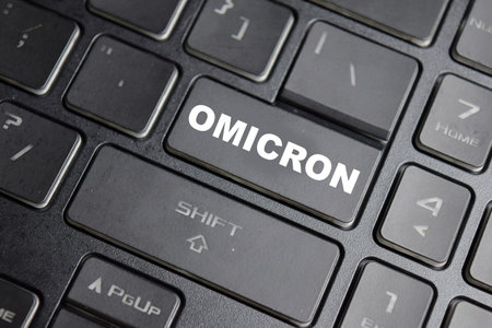 Omicron is the name given to a variant of the SARS-CoV-2 virus button on the keyboardの写真素材