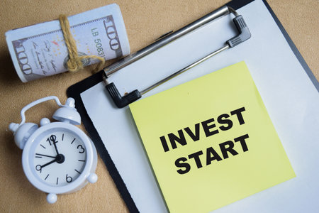 Concept of invest smart write on sticky notes isolated on Wooden Table. Business goals management and investment on new project to wealthの写真素材