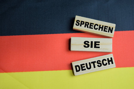 Sprechen sie deutsch on stacked wooden cubes it means Do you speak German with Germany flag.の写真素材