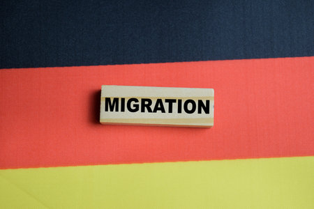 Migration on stacked wooden cubes with Germany. Business and finance conceptの写真素材