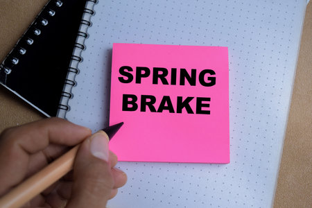 Concept of spring brake write on sticky notes isolated on Wooden Table.の写真素材