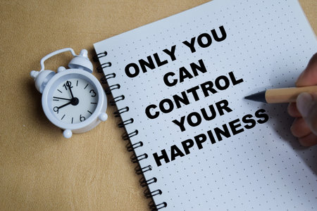 Concept of only you can control your happiness write on book isolated on Wooden Table.の写真素材