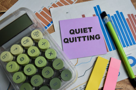 Concept of quiet quitting write on sticky notes isolated on Wooden Table.の写真素材