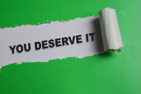 You deserve it text written in torn paperの写真素材