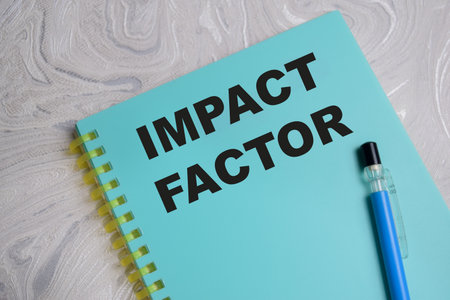 Concept of impact factor write on book isolated on Wooden Table.の写真素材