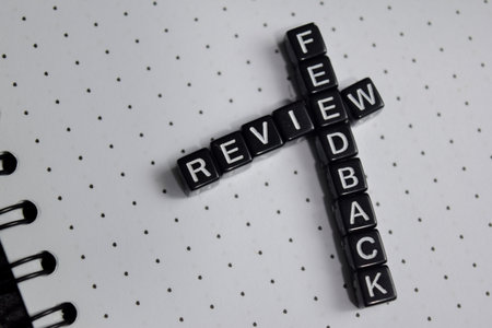 Concept of review and feedback written on wooden blocks.の写真素材