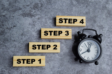 step 1 to step 4 in a row on the table. step-by-step planning conceptの写真素材