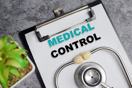 Concept of medical control write on clipboard isolated on Wooden Table.の写真素材