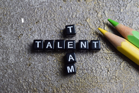 Concept of team talent words arranged with on wooden letter blocks.