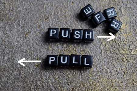 Concept of push and pull words arranged with on wooden letter blocks.の写真素材