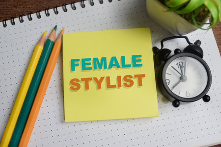 Concept of female stylist write on sticky notes isolated on Wooden Table.の写真素材