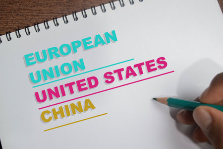 Concept of global relations labeled European, United States and China write on book isolated on Wooden Table.の写真素材