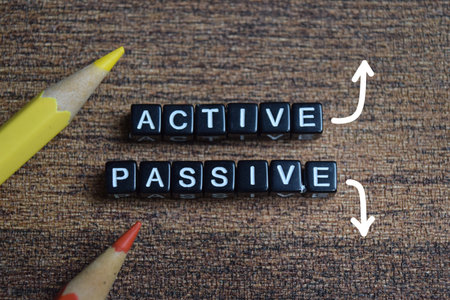 Concept of active and passive income words arranged with on wooden letter blocks.