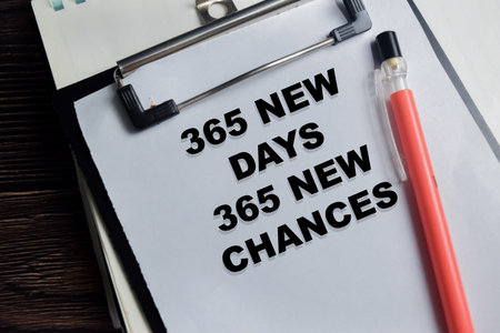 Concept of 365 new days 365 new chances write on clipboard isolated on Wooden Table.